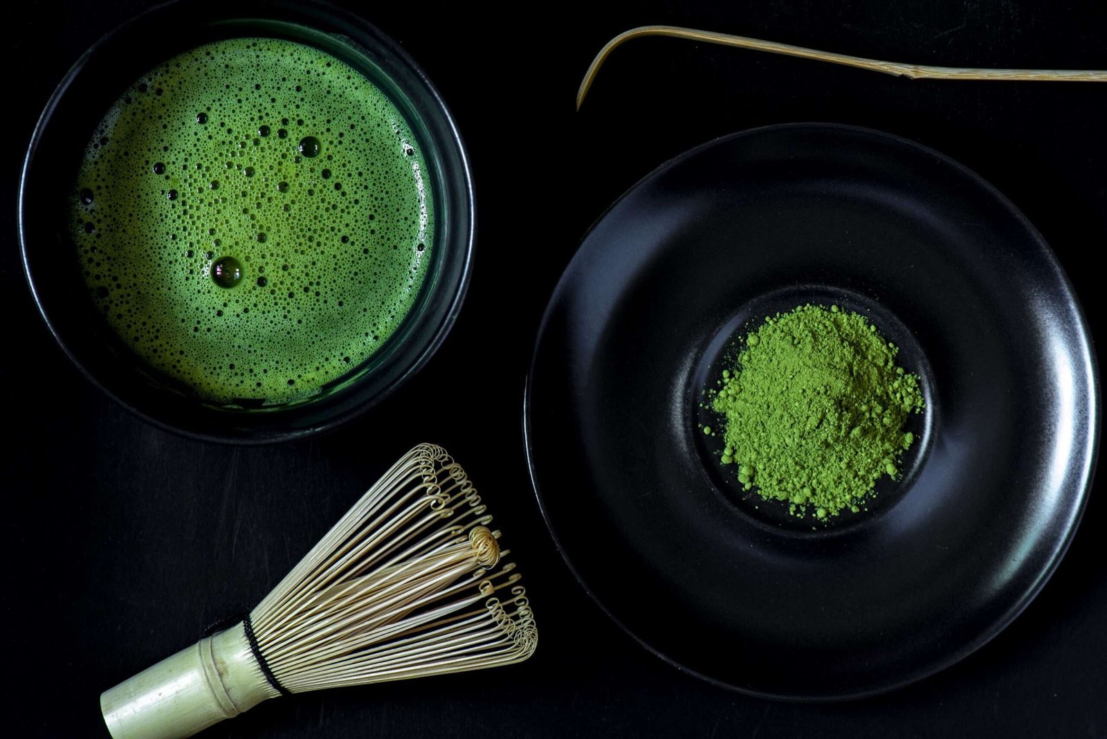 Bright green matcha powder and whisked matcha tea